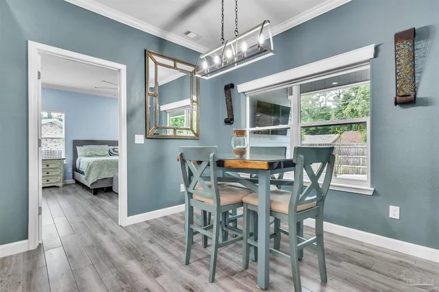 a view of a dining room with furniture window and wooden floor