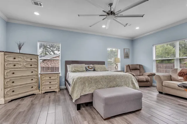 a spacious bedroom with a bed and a couch