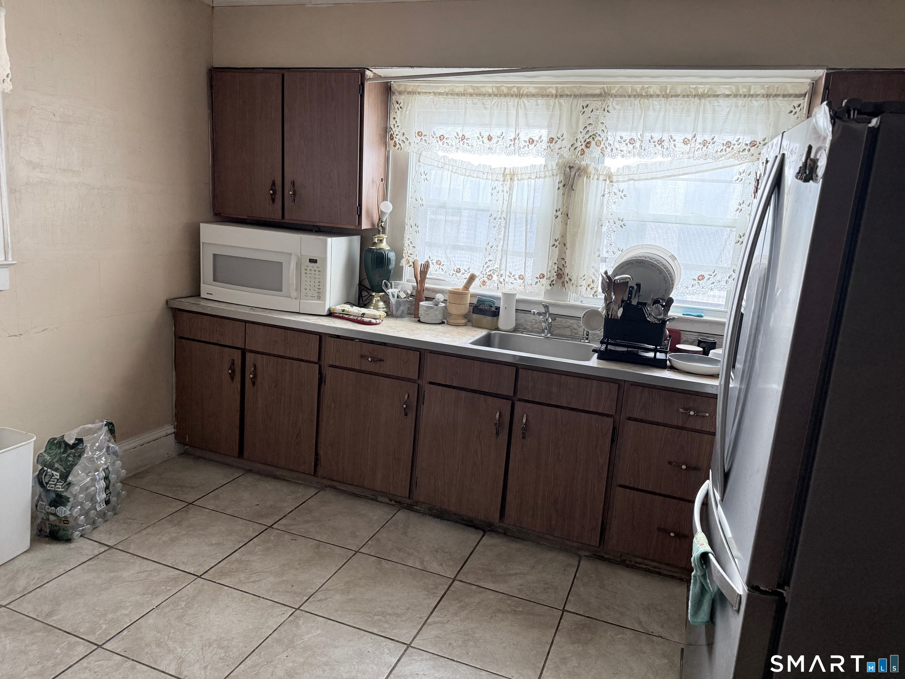 72 Brainard Street New London, CT 06320 - Photo 8 of 11 a kitchen with a sink a stove and cabinets