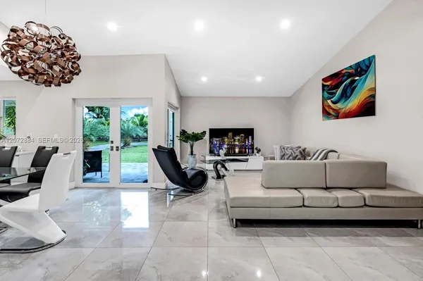 a living room with furniture a large window and a flat screen tv