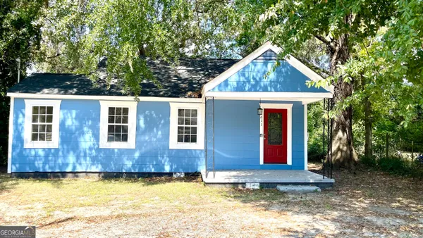 a view of a house with pool yard and trees