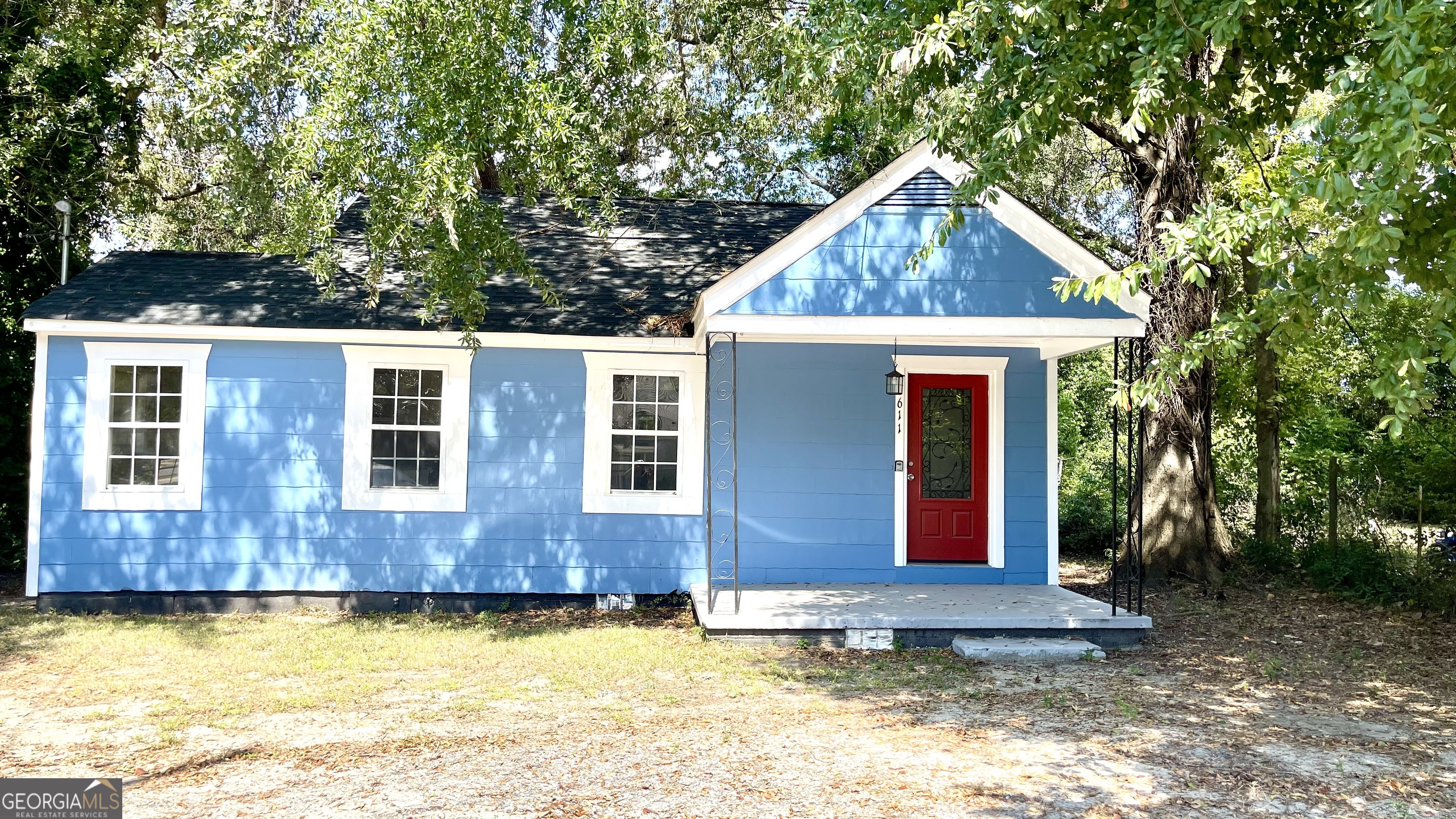 611 West Moore Street Dublin, GA 31021 - Photo 1 of 15 a view of a house with pool yard and trees