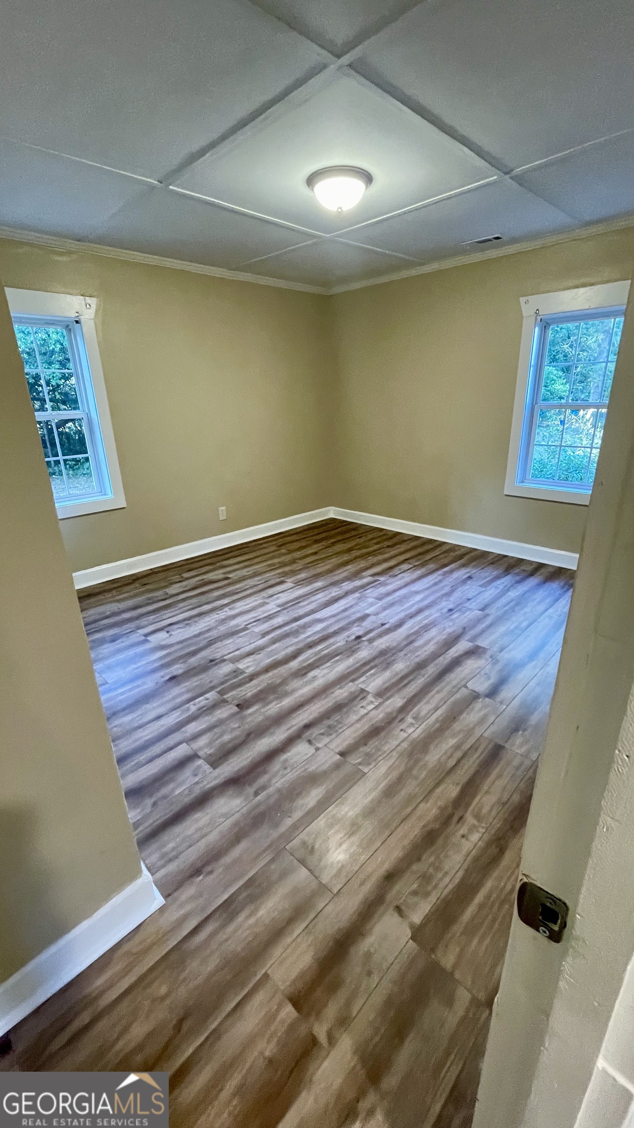 611 West Moore Street Dublin, GA 31021 - Photo 12 of 15 a view of an empty room with wooden floor