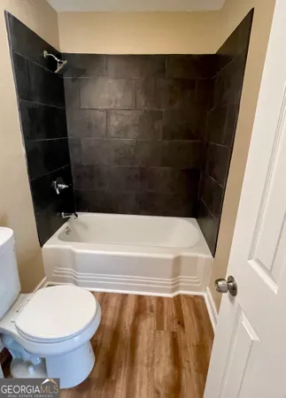 a bathroom with a toilet and a bathtub