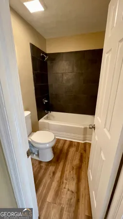 a bathroom with a toilet and a shower