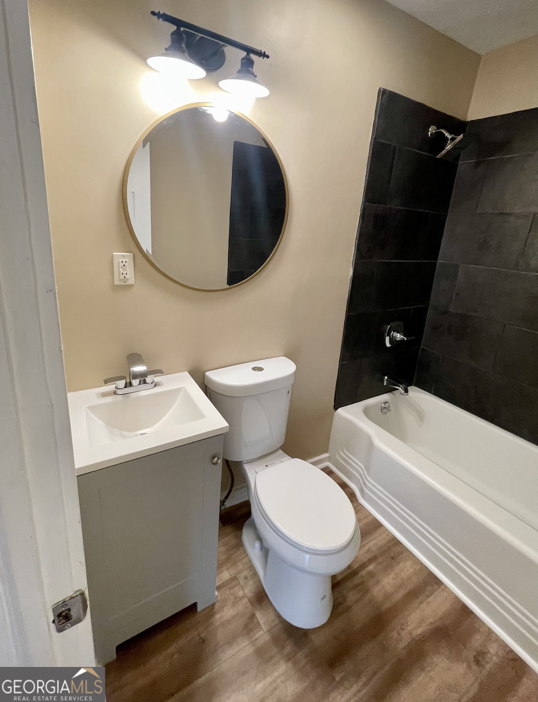 611 West Moore Street Dublin, GA 31021 - Photo 15 of 15 a white toilet sitting next to a bathroom sink and a mirror