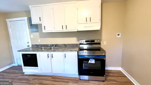 a kitchen with stainless steel appliances granite countertop a stove and a refrigerator