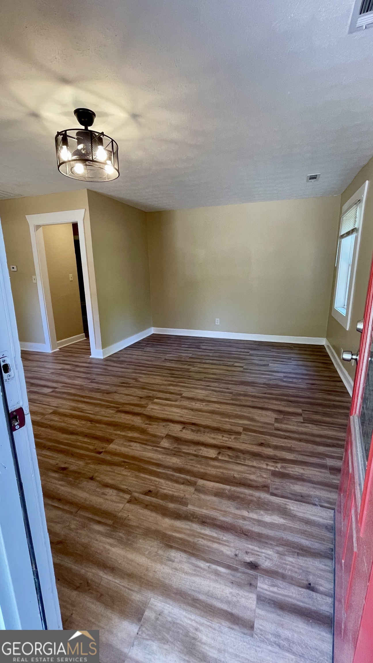 611 West Moore Street Dublin, GA 31021 - Photo 6 of 17 a view of empty room with wooden floor