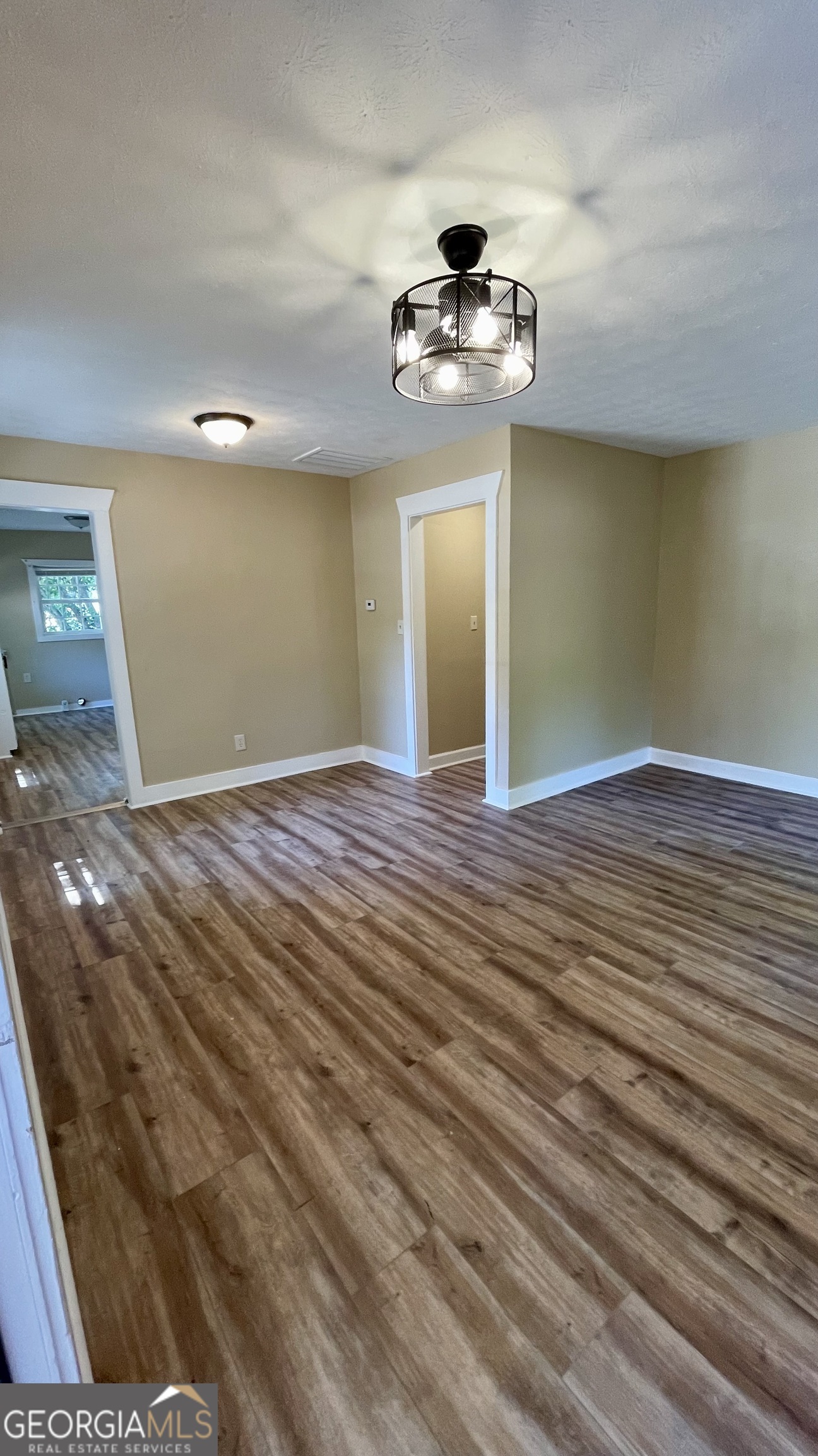 611 West Moore Street Dublin, GA 31021 - Photo 8 of 17 a view of an empty room with wooden floor