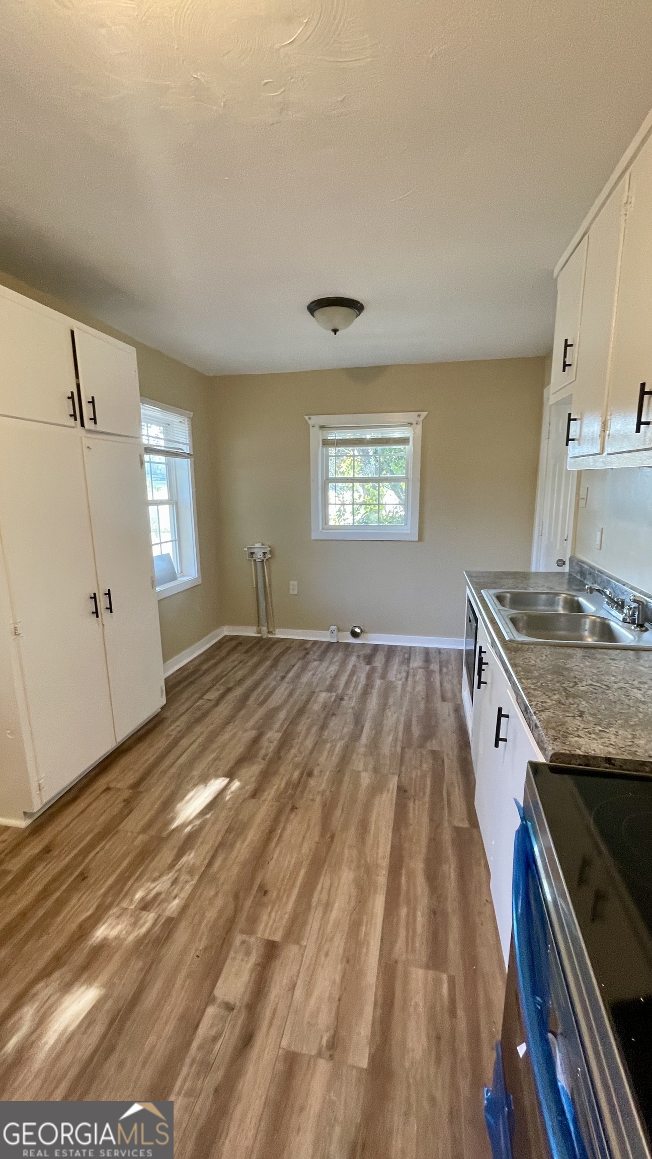 611 West Moore Street Dublin, GA 31021 - Photo 8 of 15 a view of a kitchen cabinets a sink and wooden floor