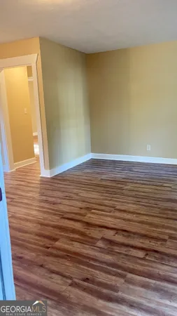 a view of a room with wooden floor