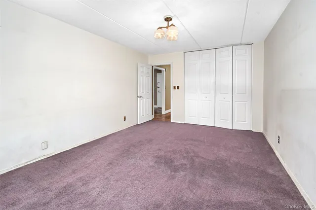 a view of an empty room and a window