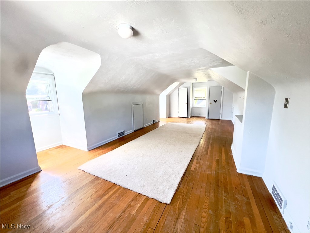 2024 Kirk Road Youngstown, OH 44511 - Photo 24 of 36 Bonus room featuring lofted ceiling, dark hardwood / wood-style floors, and a textured ceiling