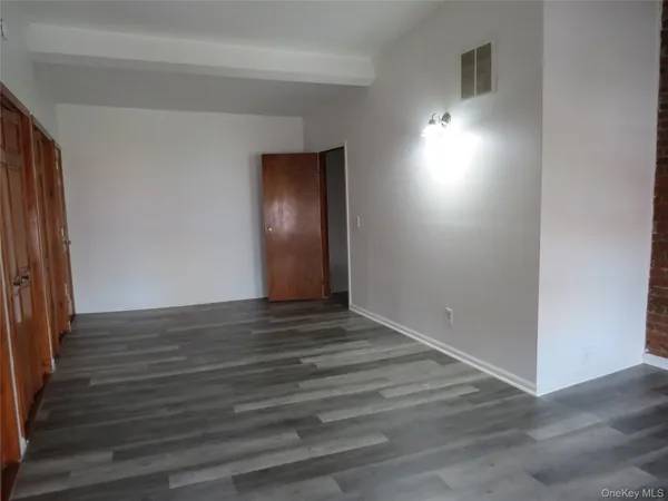 a view of wooden floor and windows in a room