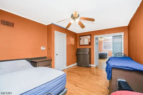 a view of an empty room with cabinet and stairs