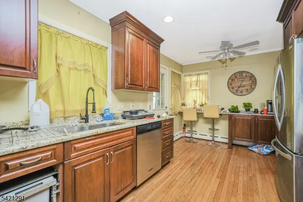 a view of an empty room with a window and fireplace