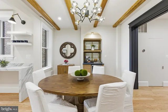 a kitchen with granite countertop a stove and a wooden floors