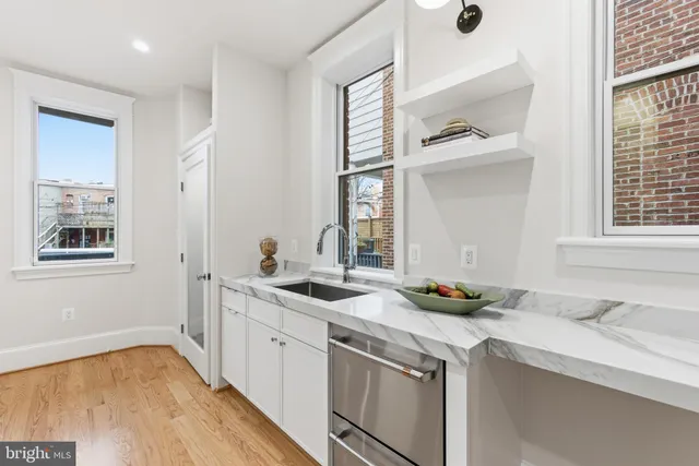 a spacious bedroom with a bed and a large window