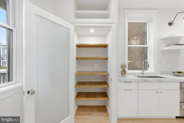 a bedroom with bed and a chandelier