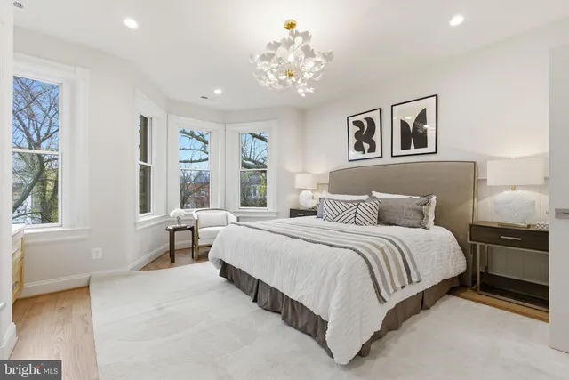 a bathroom with a granite countertop sink a toilet and a mirror