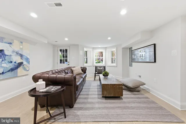 a living room with a bed and a window