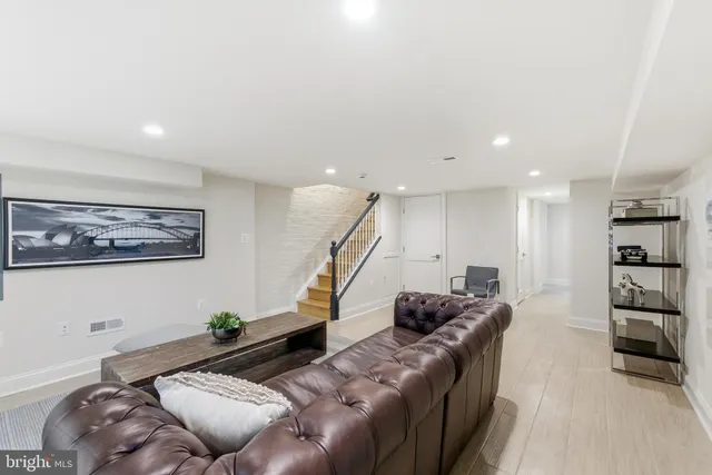 a bathroom with a granite countertop toilet sink and mirror