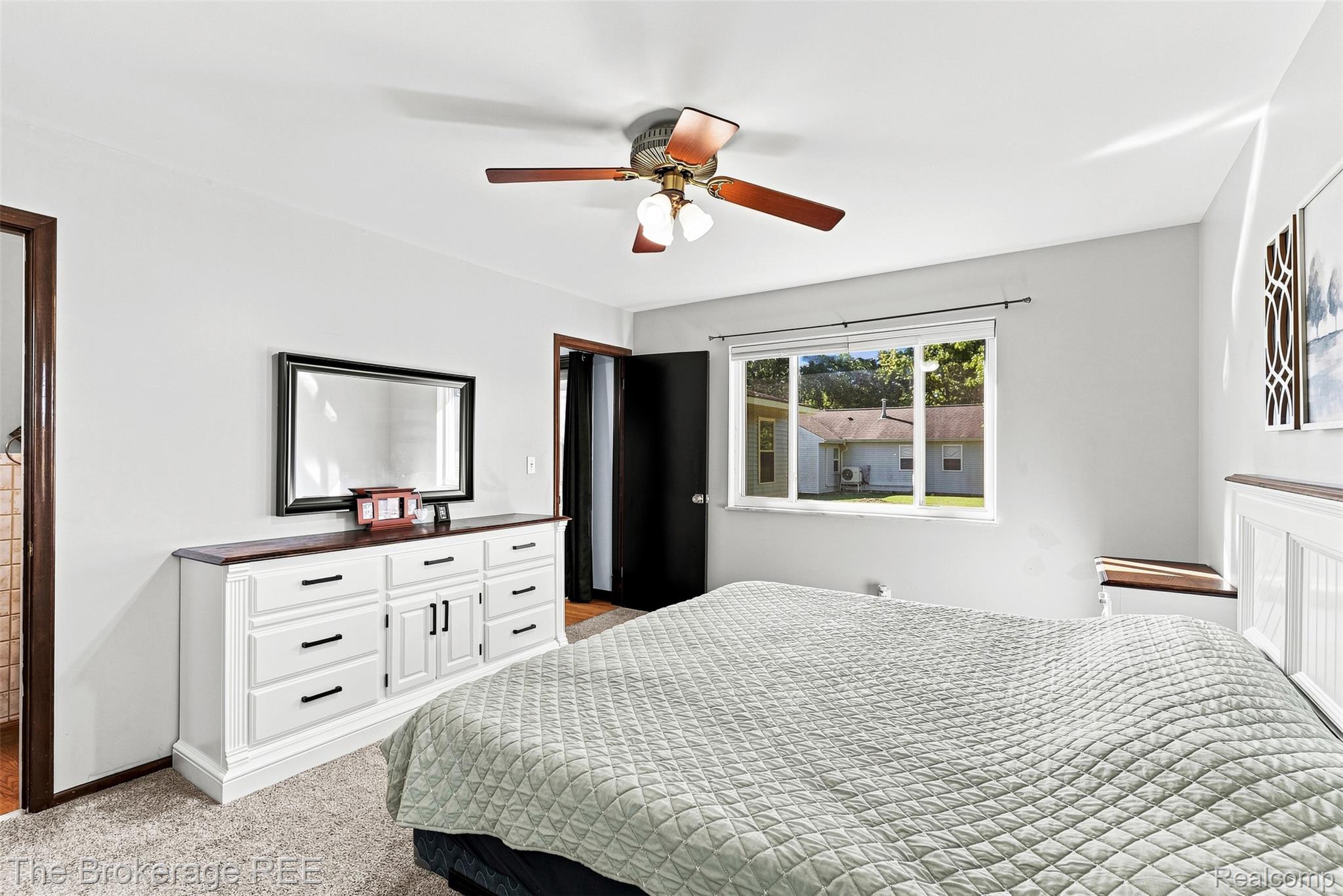 4443 North Gale Road Davison, MI 48423 - Photo 28 of 36 Ceiling fan with wood-finish blades, white walls, and a window with a dark frame