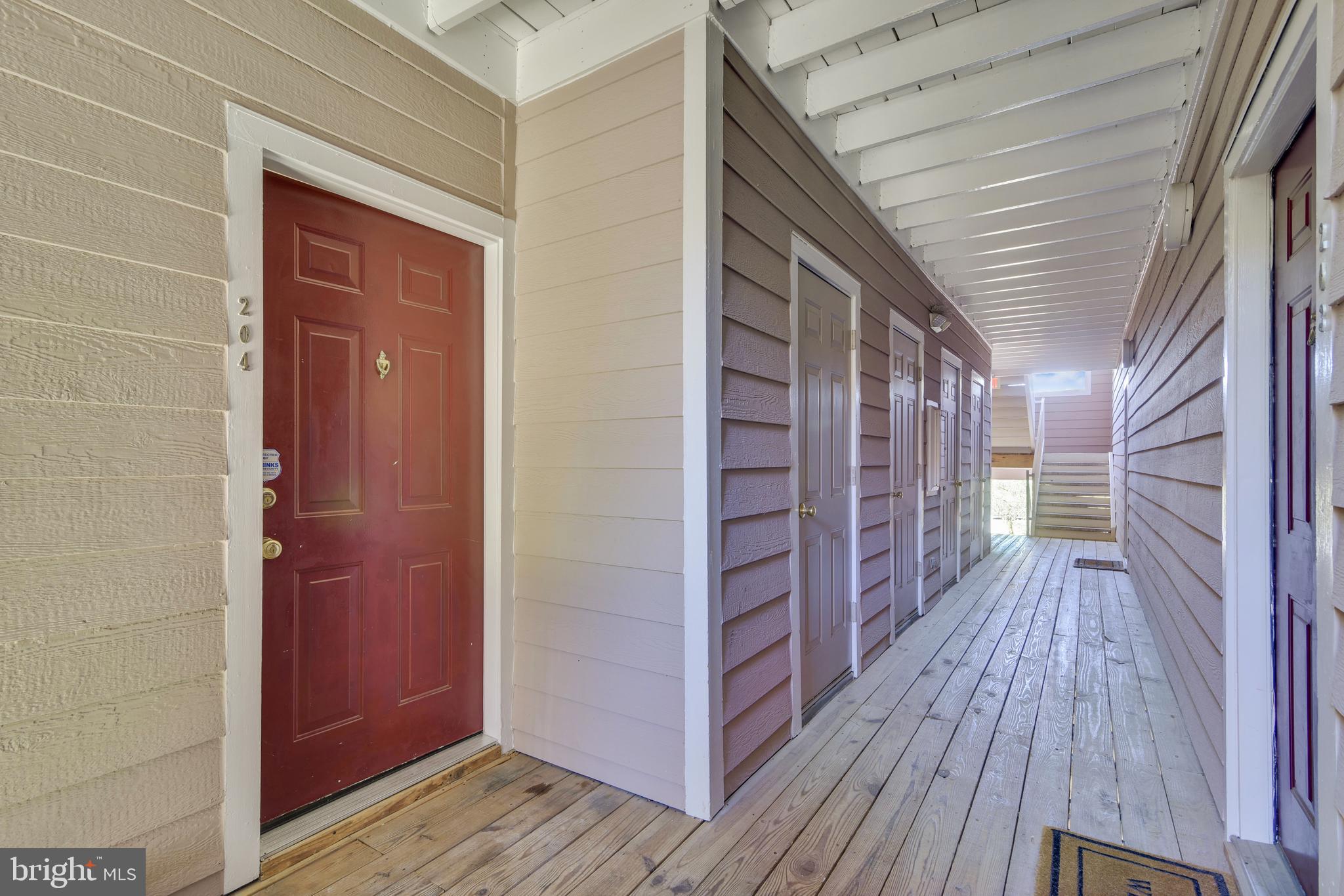 20991 Timber Ridge Terrace, Unit 204 Ashburn, VA 20147 - Photo 25 of 52 Front Door And Exterior Hallway