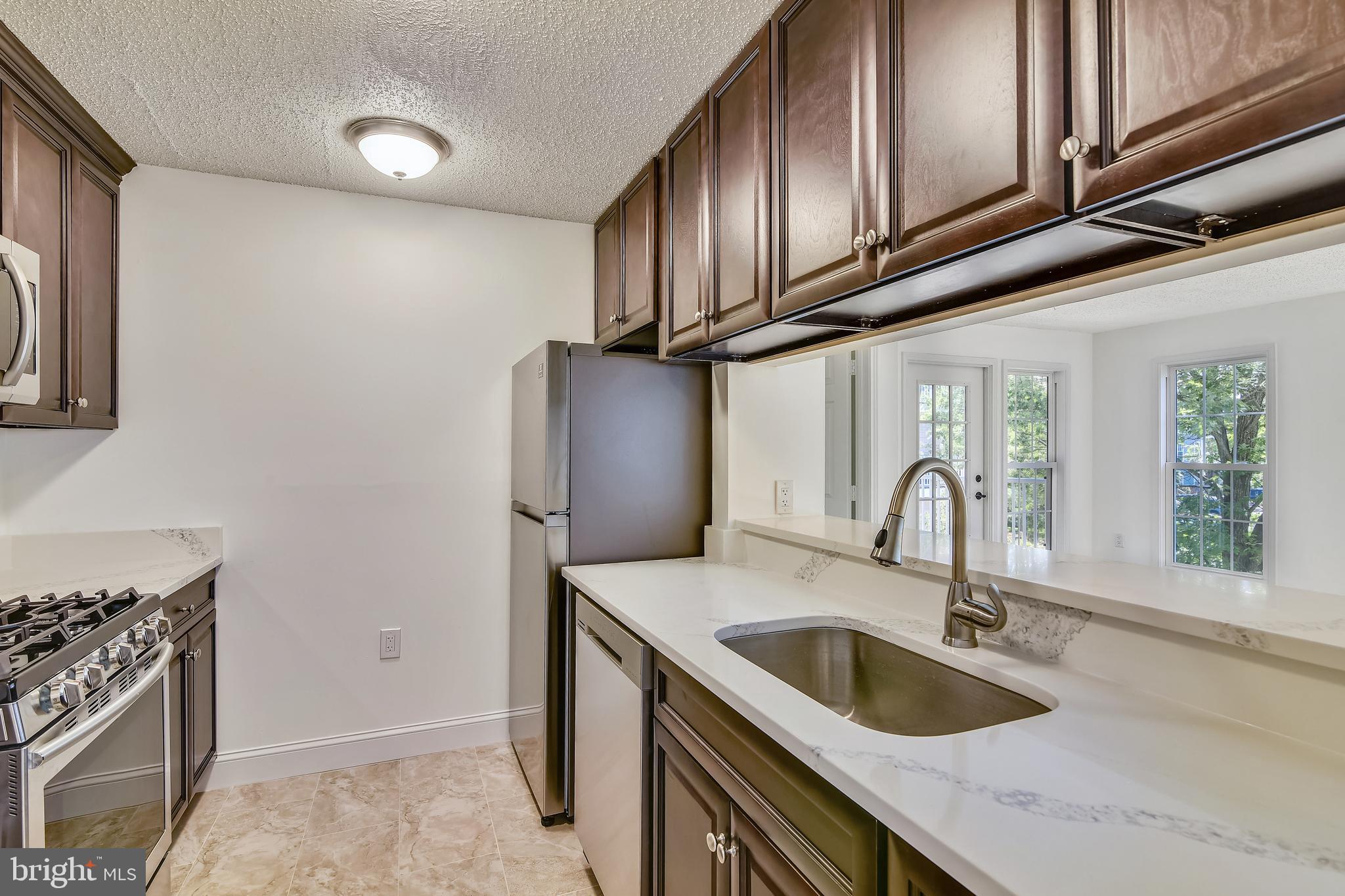 20991 Timber Ridge Terrace, Unit 204 Ashburn, VA 20147 - Photo 27 of 52 Kitchen with Quartz Counters