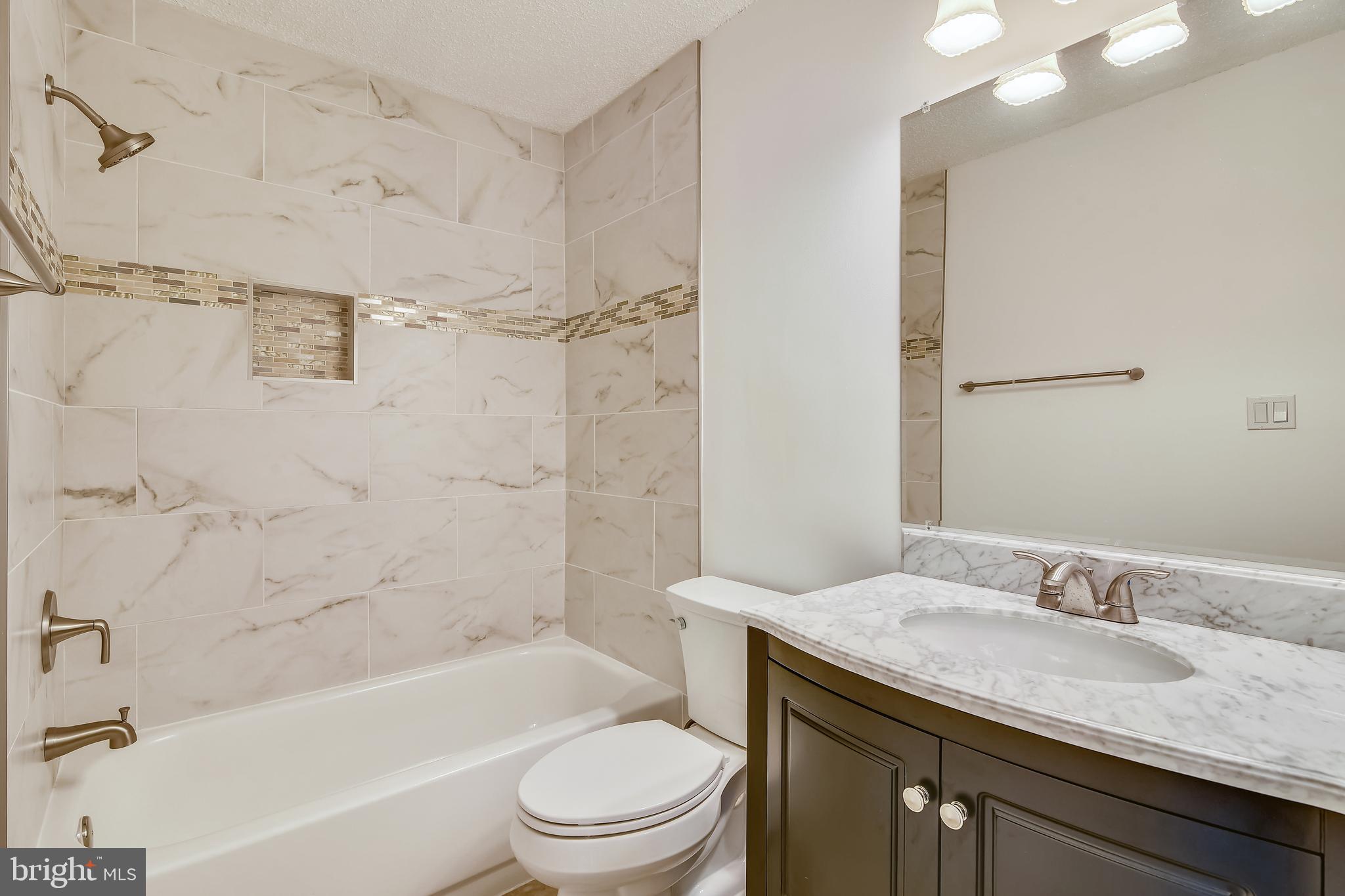 20991 Timber Ridge Terrace, Unit 204 Ashburn, VA 20147 - Photo 39 of 52 Master Bath with granite counter and Tile