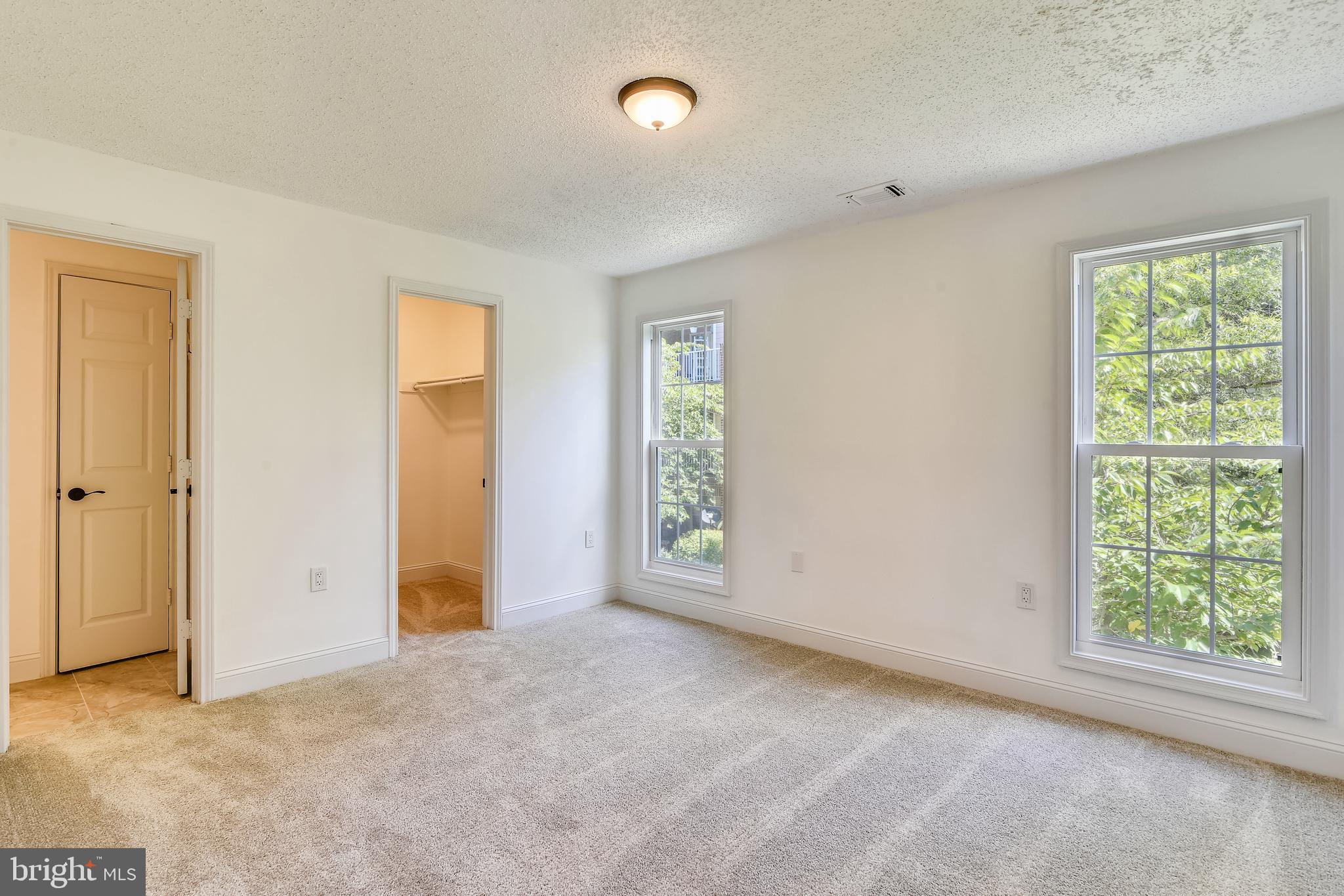 20991 Timber Ridge Terrace, Unit 204 Ashburn, VA 20147 - Photo 40 of 52 Master Bedroom With Walk-In Closet and On-Suite