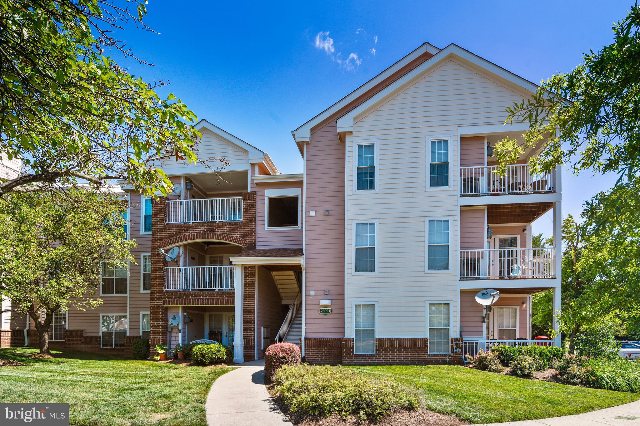 20991 Timber Ridge Terrace, Unit 204 Ashburn, VA 20147 - Photo 10 of 52 Front Elevation and Exterior Walkway