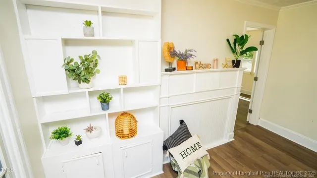 a view of a room with wooden floor and windows