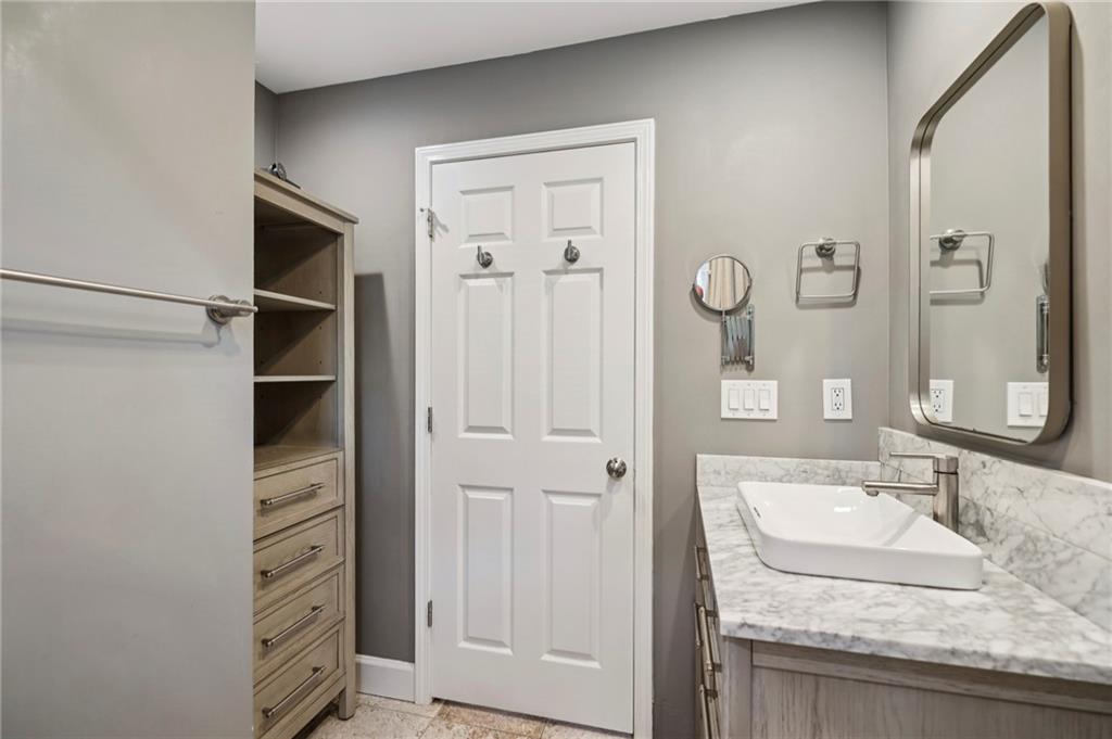 1952 Wingate Road Chamblee, GA 30341 - Photo 13 of 23 a bathroom with a granite countertop sink a vanity and a mirror