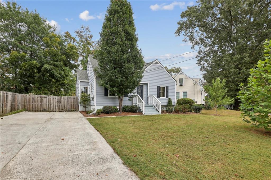 1952 Wingate Road Chamblee, GA 30341 - Photo 2 of 23 a front view of a house with a yard and garage