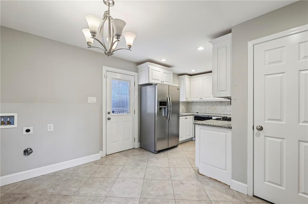 1952 Wingate Road Chamblee, GA 30341 - Photo 6 of 23 a kitchen with stainless steel appliances granite countertop a refrigerator a sink dishwasher a stove and white cabinets