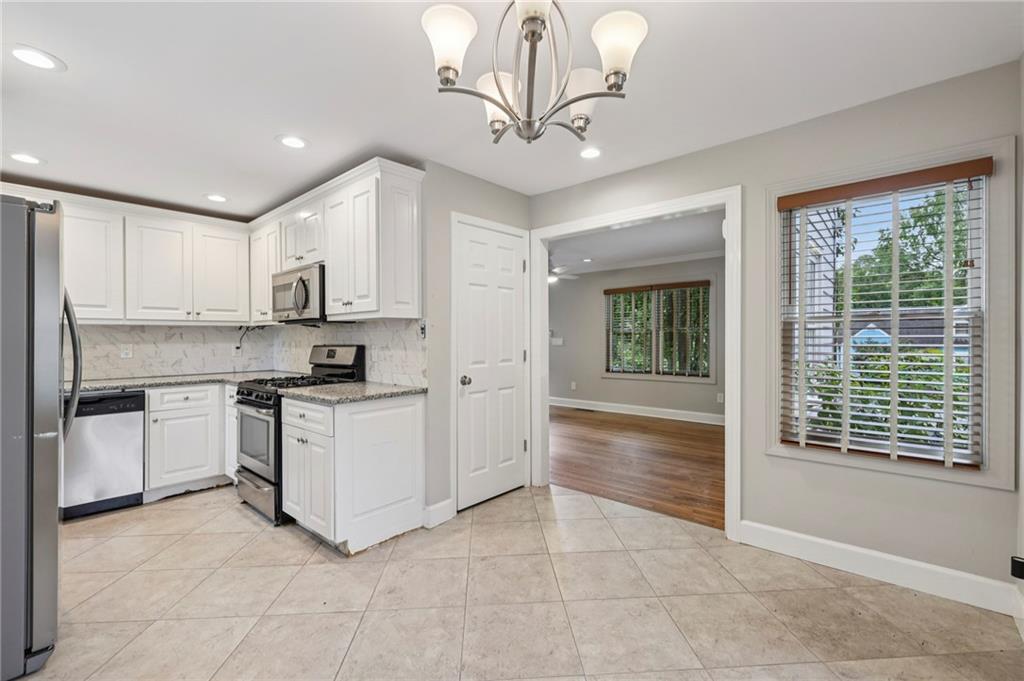 1952 Wingate Road Chamblee, GA 30341 - Photo 7 of 23 a kitchen with white cabinets and white appliances