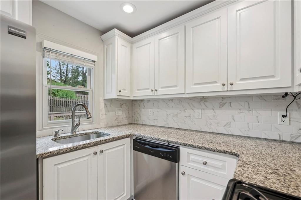 1952 Wingate Road Chamblee, GA 30341 - Photo 8 of 23 a kitchen with granite countertop white cabinets and a sink