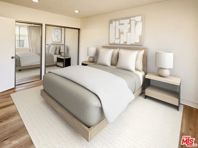 a bedroom with a bed and a night stand