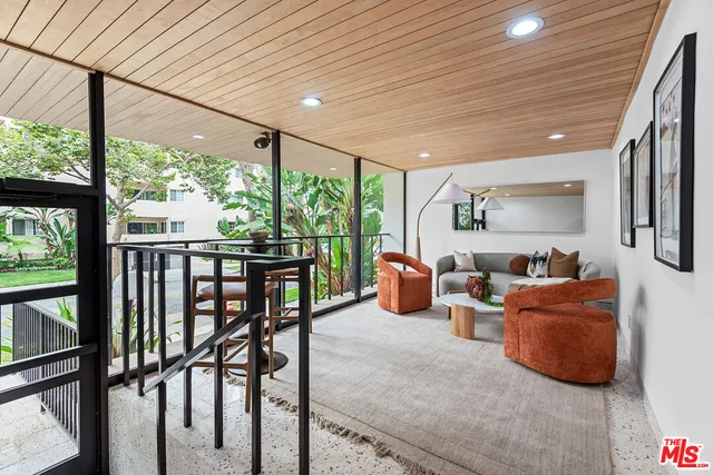 a living room with furniture tv and a large window