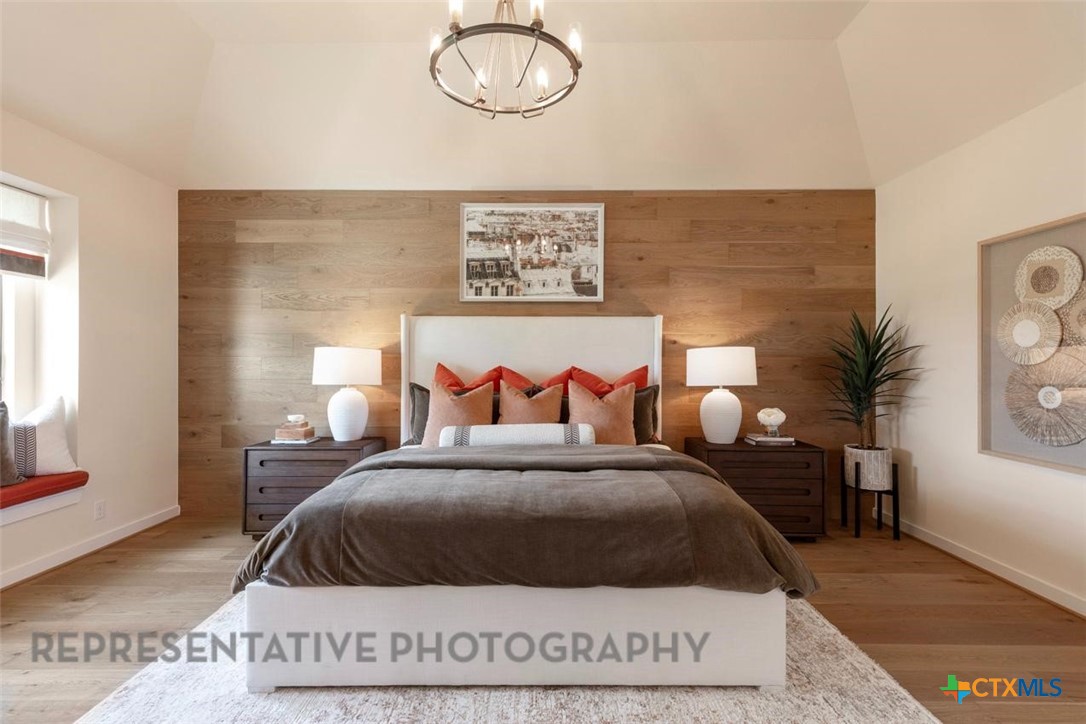 9501 Boathouse Drive Austin, TX 78744 - Photo 21 of 32 a bedroom with a bed a potted plant and a window