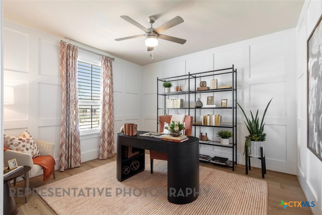 9501 Boathouse Drive Austin, TX 78744 - Photo 26 of 32 a workspace with furniture and a potted plant