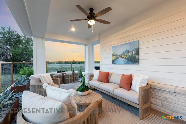 a living room with furniture a rug and a chandelier