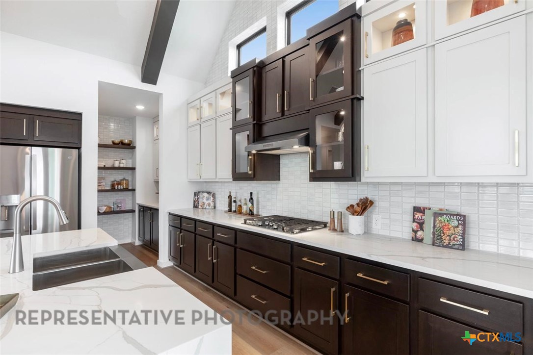 9501 Boathouse Drive Austin, TX 78744 - Photo 17 of 32 a kitchen with stainless steel appliances a sink stove and cabinets