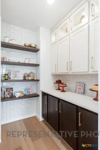 a bathroom with a sink double vanity granite tub shower and a mirror