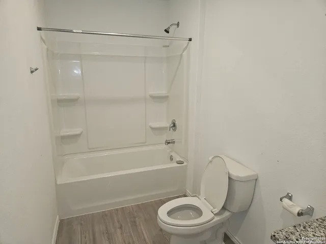 a bathroom with a toilet and shower