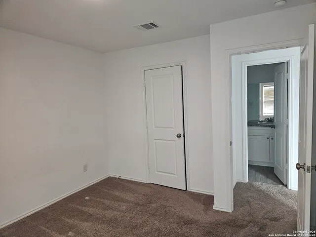 a view of an empty room and closet