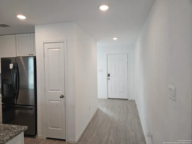 a view of hallway with wooden floor