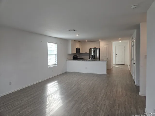 a view of a kitchen with a sink and a window