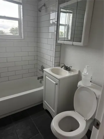 a bathroom with a toilet a sink and bathtub